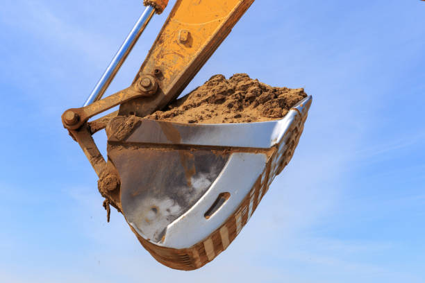 istock Excavator bucket againest the blue sky 948516676