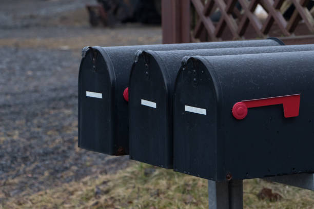 istock Group of Black mailboxes in front of a house.postboxes in rainy day before winter 948516796
