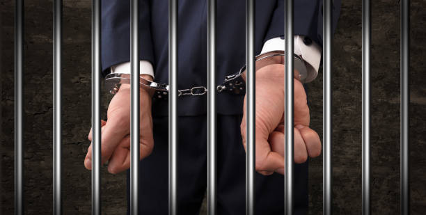 istock Close handcuffed man in jail 948519422