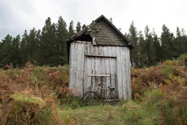 A rusty bicycle discarded in front of an old shed in Scotland