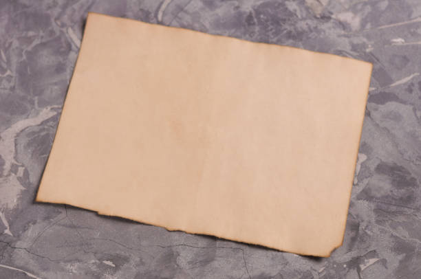 istock One old blank rectangle burnt sheet of paper on gray old broken cement 948524040