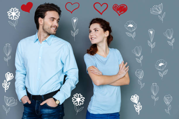 istock Romantic young couple looking at each other and kindly smiling 948524564