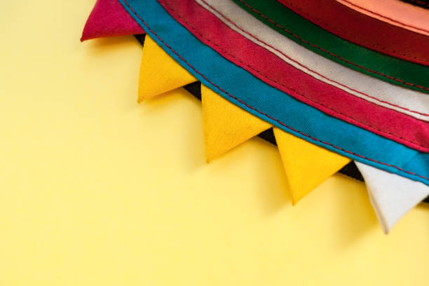 istock Close-up part of circle handmade striped colorful fabric with triangular edges on yellow background. 948524928
