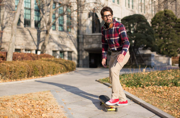istock A Student about to Ride a Skateboard Towards Direction of Path. 948525012