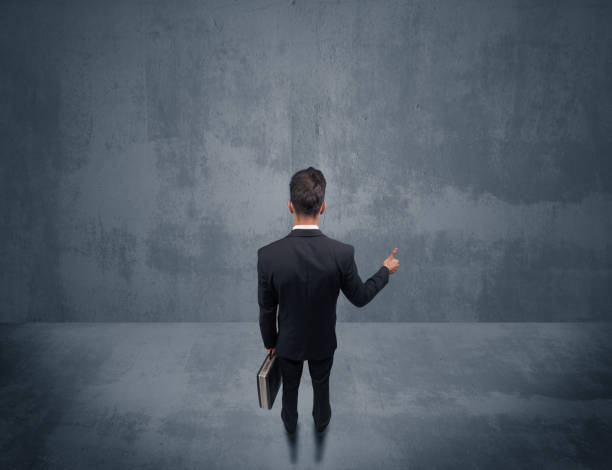 istock Businessman standing in front of urban wall 948531582