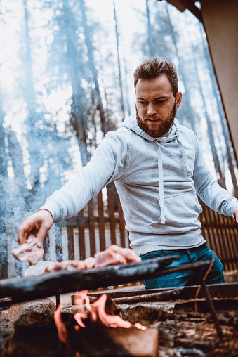 Handsome Male Preparing Barbecue on Family Picnic