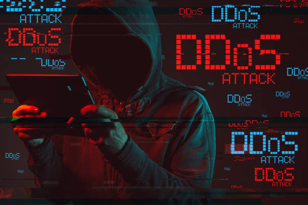 Distributed denial of service or DDoS attack Distributed denial of service or DDoS attack concept with faceless hooded male person using tablet computer, low key red and blue lit image and digital glitch effect distributed denial of stock pictures, royalty-free photos & images