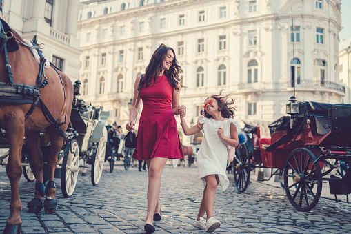 Cute mom with child sightseeing in Vienna