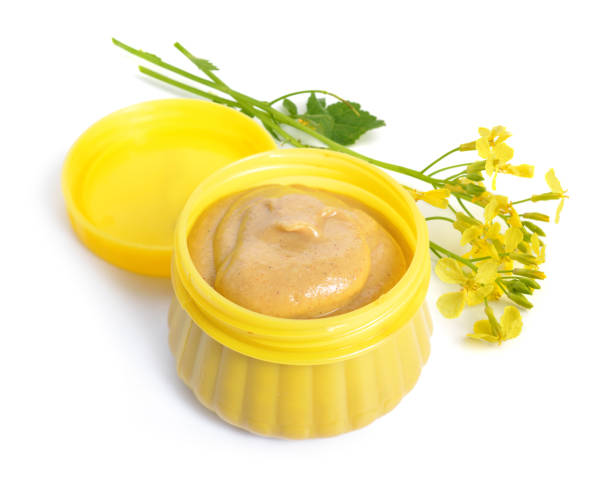 istock Mustard sauce with flowers. Isolated on white background 948540152