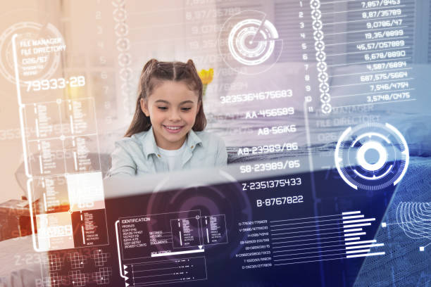 istock Positive girl smiling while sitting in front of a modern computer 948540154