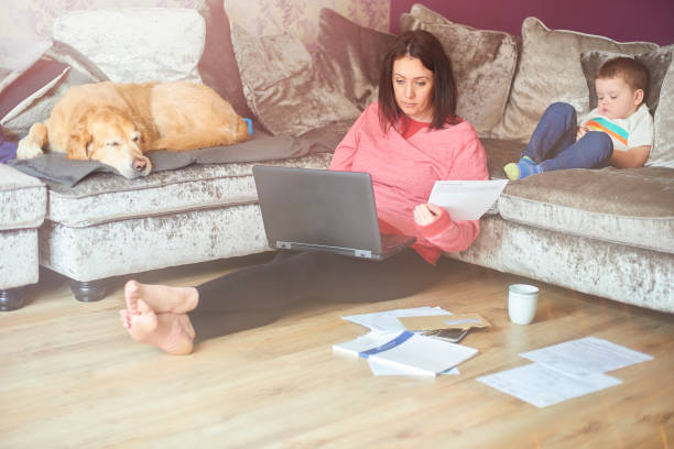 Young mother working from home with toddler