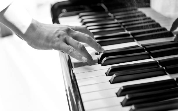 istock Woman hand playing piano 948542598
