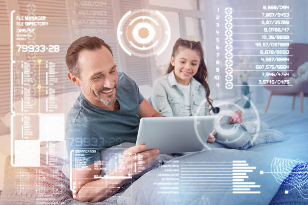 istock Emotional man holding a tablet and his curious daughter looking at it 948543518