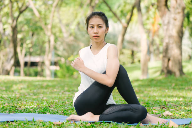 istock Young asian woman yoga outdoors keep calm and meditates while practicing yoga to explore the inner peace. Yoga and meditation have good benefits for health. Yoga Sport and Healthy lifestyle concept. 948543566
