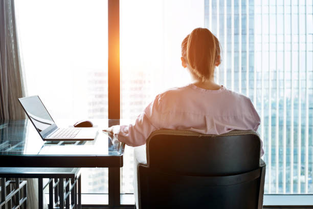 istock Woman sitting and looking out the window 948543952