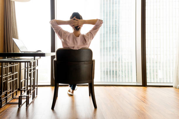 istock Woman sitting and looking out the window 948544076