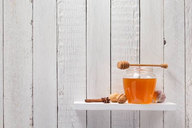 istock glass jar full of honey on white background 948544406
