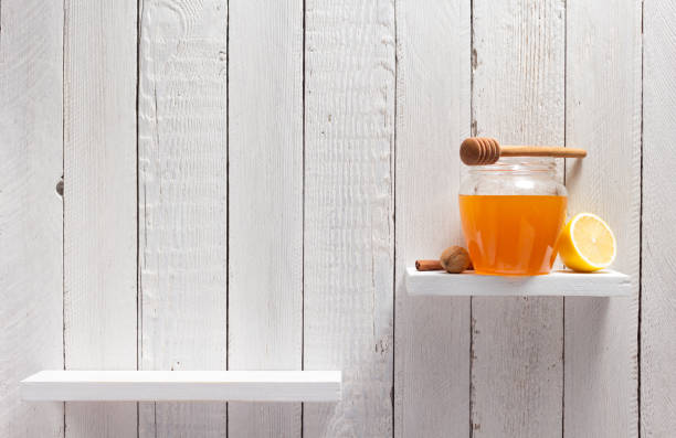 istock glass jar full of honey on white background 948544486