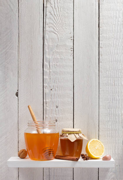 istock glass jar full of honey on white background 948544564