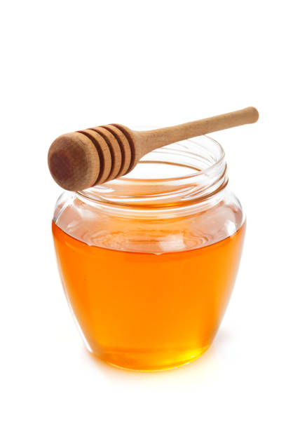 istock glass jar full of honey on white background 948544648