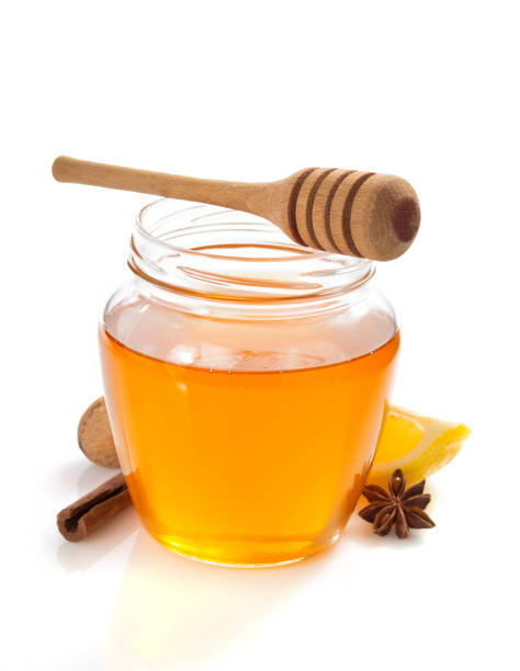 istock glass jar full of honey on white background 948544680