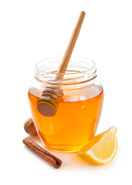 istock glass jar full of honey on white background 948544682