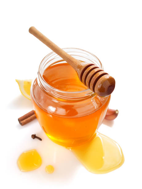 istock glass jar full of honey on white background 948544704