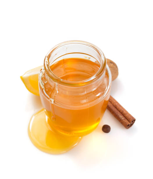 istock glass jar full of honey on white background 948544718