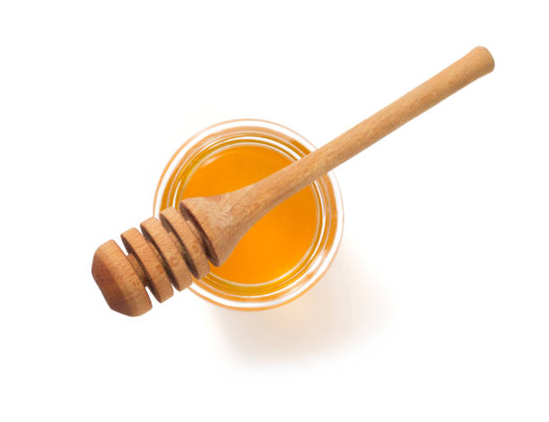 istock glass jar full of honey on white background 948544738