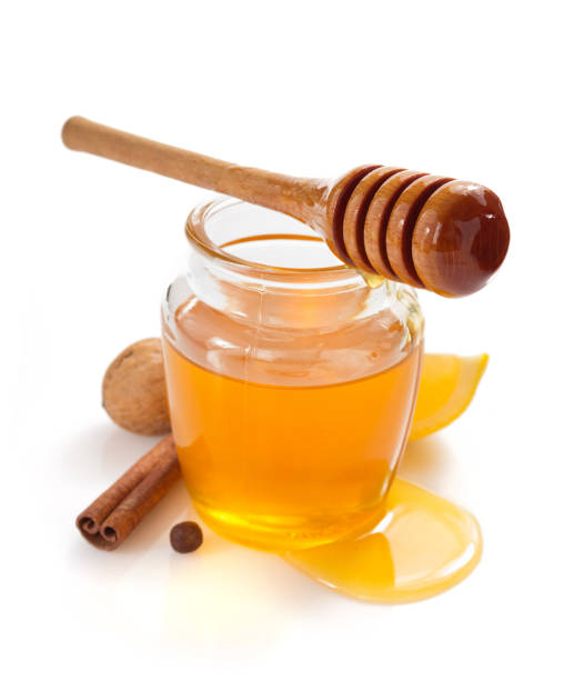 istock glass jar full of honey on white background 948544820