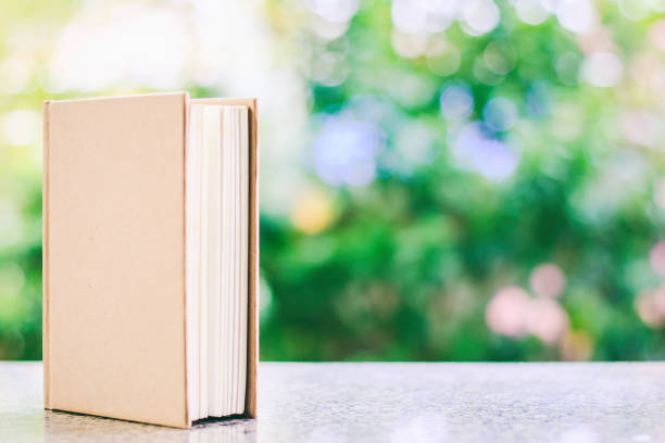 istock A book against blurred natural green background with copy space for education and learning concept 948544942