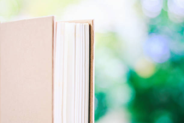 istock A book against blurred natural green background with copy space for education and learning concept 948545022