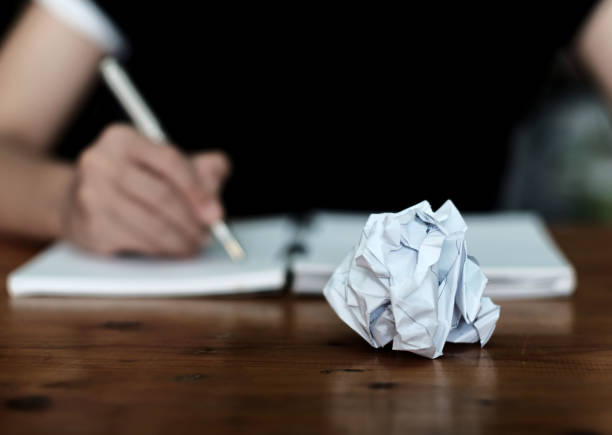 Paper ball during writing Businessman writing down on a notebook . Concept of new creative ideas, business plan and creativity. oops stock pictures, royalty-free photos & images