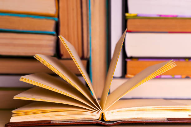 istock Open book, hardback books on bright colorful background. 948552360