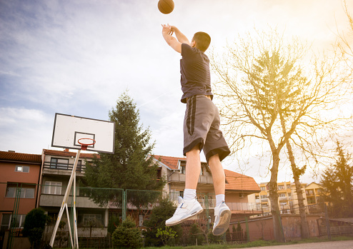 Young basketball player is holding ball