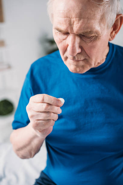 istock selective focus of senior man with medicine in hand 948553012
