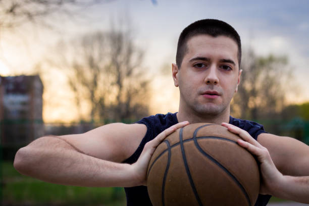 istock Young basketball player is holding ball 948555906