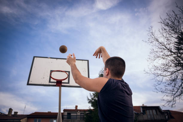 Young basketball player is holding ball