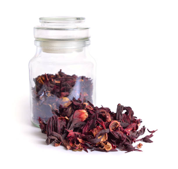 istock Dry hibiscus tea in glass ja. Isolated on white background. 948556166