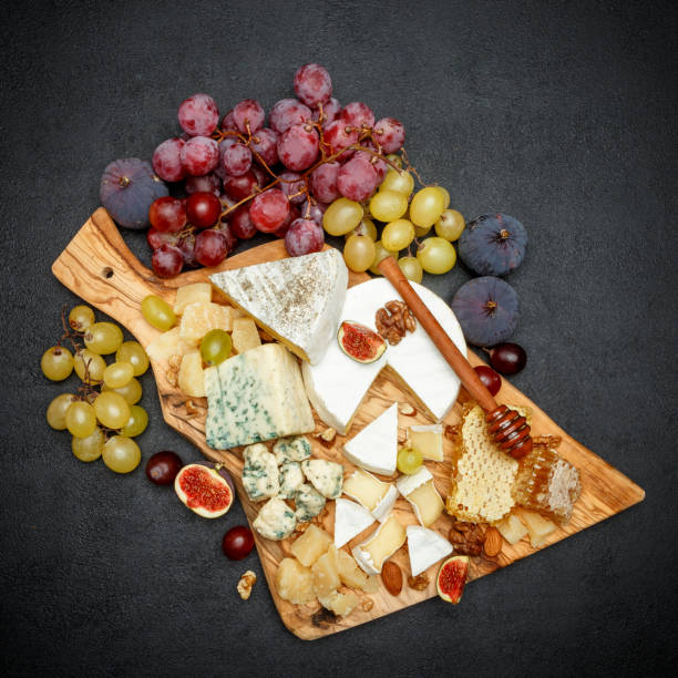 istock Camembert cheese with honey, figs, walnuts on wooden board 948556186
