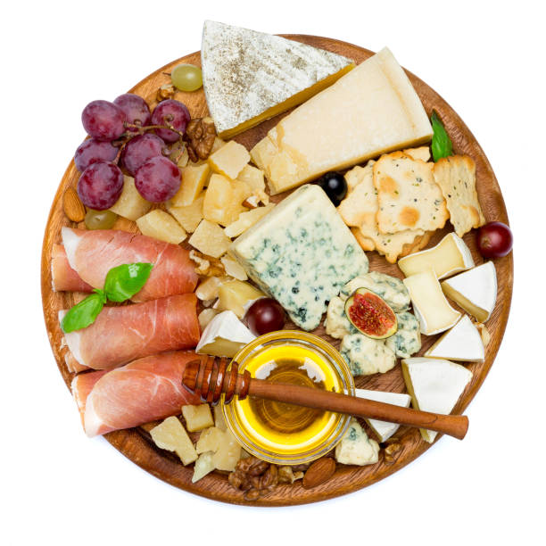 istock Camembert cheese and prosciutto with honey, figs, walnuts on wooden board 948556522