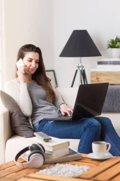 istock Woman working on a computer and talking on the phone 948559362