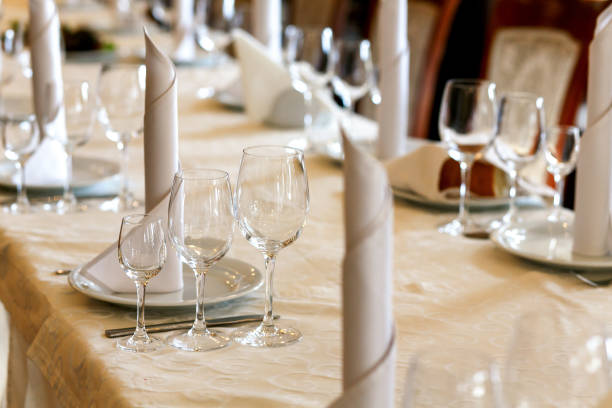 istock stylish empty glasses and plates at setting at elegant table for wedding reception, catering in restaurant 948566756
