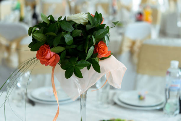 istock bouquet with orange rose on wedding table at reception in restaurant 948567618