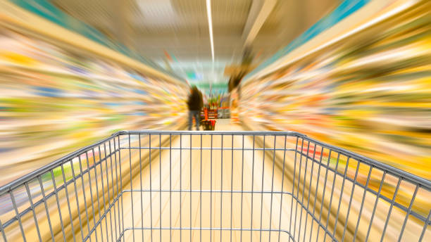 Shopping cart speeding Shopping cart speeding in the supermarket aisle deep pick stock pictures, royalty-free photos & images
