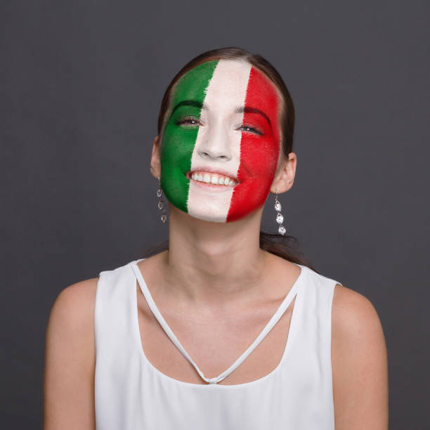 istock Young woman with Italy flag painted on her face 948571056
