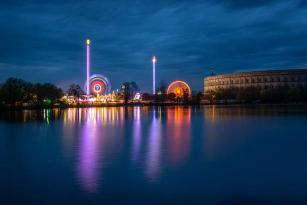 istock Spring fair lights and reflections at lake Dutzendteich in Nuremberg during blue hour 948571602
