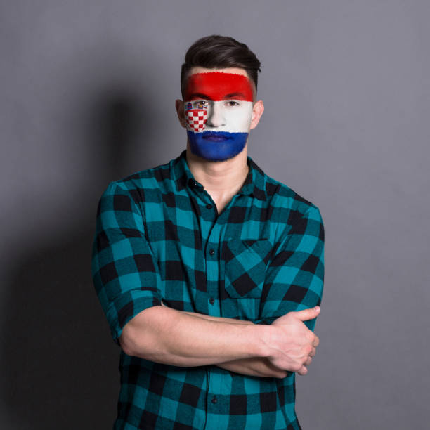 istock Young man with Croatia flag painted on his face 948572006