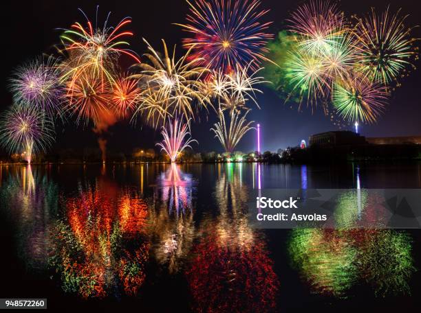 Multiple Fireworks With Reflections Over Lake Dutzendteich At Spring Fair In Nuremberg Stock Photo - Download Image Now