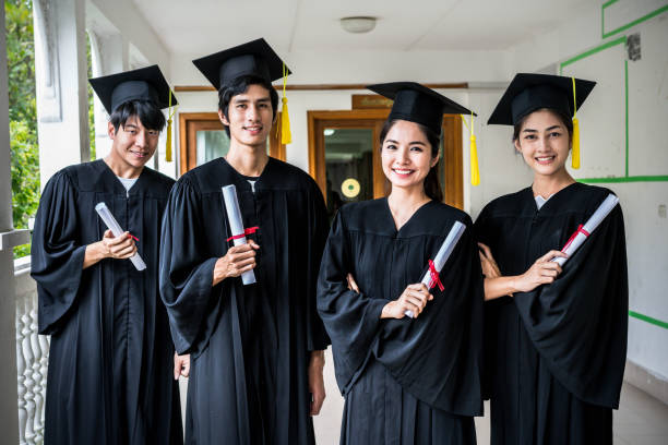 istock Group of multiethnic students with diplomas. 948575792